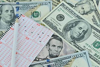 Lottery ticket and pencil on dollar background