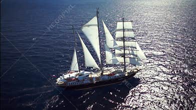 Sailing ship in calm weather sailing on the ocean