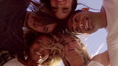 Low angle view of five friends in a huddle