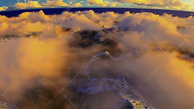Cruising above clouds and snowy mountain peaks