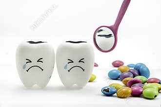 Tooth decay is crying with dental mirror