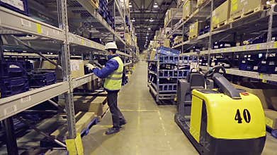 Worker checking cargo in warehouse