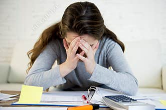 Young worried woman suffering stress doing domestic accounting paperwork bills