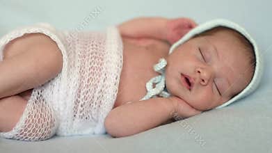 Newborn baby lying on a blue blanket
