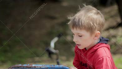 Boy on merry-go-round in park. Carousel