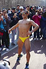 Strong man without clothes showing muscles in Beijing Color Run Event