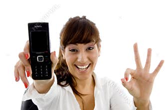 Smiling female executive holding mobile