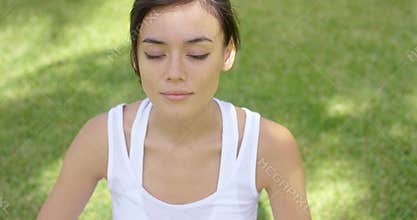 Calm young woman in white blouse with grin