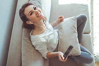 Girl listening to music while sitting on the couch