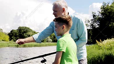 Grandfather and grandson fishing on river berth 3
