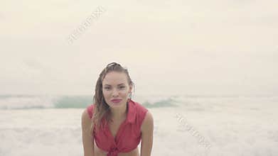 Sensual woman wearing shirt and bikini bottom on a beautiful summer day at the beach