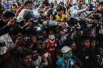 Journalists and photographers competing with each other while covering an event
