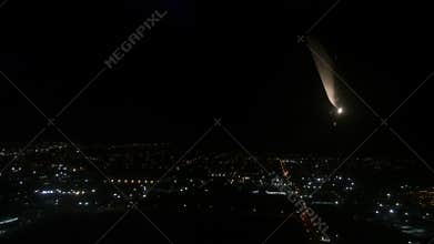 Airliner plane fly above a city at night