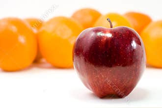 one red apple and bunch of oranges