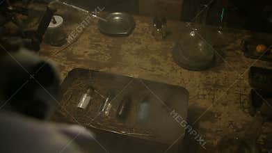 Strange scientist opens a steel box with ingredients