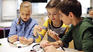 Happy children making high five at robotics school