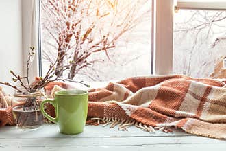 Cup of coffee on the window sill