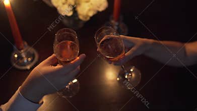 Hands man and a woman who clink glasses with champagne. Valentines day. making a marriage proposal.