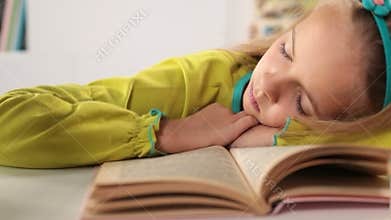Little girl asleep on her book