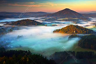 Czech typical autumn landscape. Hills and villages with foggy morning. Morning fall valley of Bohemian Switzerland park. Hills wit