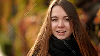 Close Up Woman Portrait Outdoor. Smiling Young Girl with Long Hair Backlit by Sun. Front View.