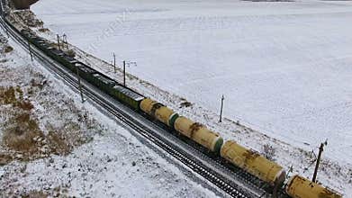 Aerial. Freight train with petroleum tanks passing by the railway.