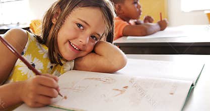Portrait of girl studying in classroom