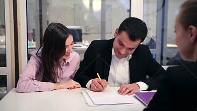Happy couple signing real-estate contract