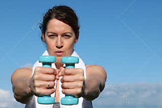 Fit woman exercising with weights