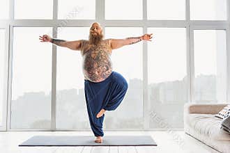 Calm fat man relaxing with meditation