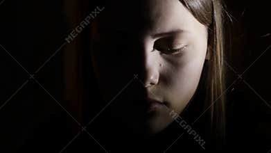 2Depressed teen girl is scared by something in the dark. 4K UHD.