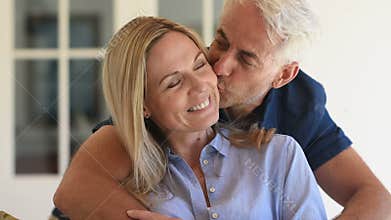 Man embracing woman