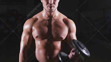Handsome power athletic man with dumbbell