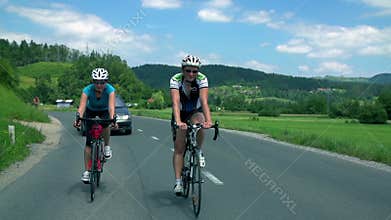 Man and woman cycling together