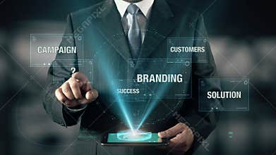 Businessman with Corporate Strategy concept choose from Branding Solution Campaign Customers using digital tablet