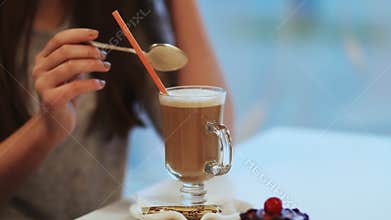 Girl drinking chocolate milk shake.
