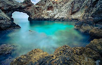 A small sea lagoon with a stone arch, Crete