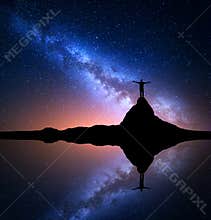 Milky Way and man on the rock. Galaxy, Universe