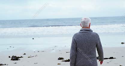 Senior man walking on the beach
