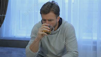 Man drinks tea at home
