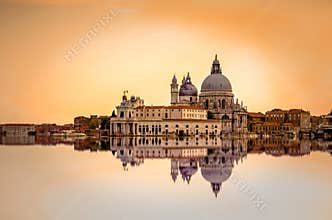 Basilica di Santa Maria della Salute reflected on the water surface, Venice, Italy.