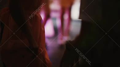 Close-up view of crowd dancing at night club. Group of people in dress and costumes have fun. Prom ball of students.