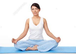 Young woman doing yoga exercise on blue mat