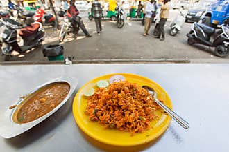 Cafe with street food - indian vegeterian biryani and lentil daal in indian style.