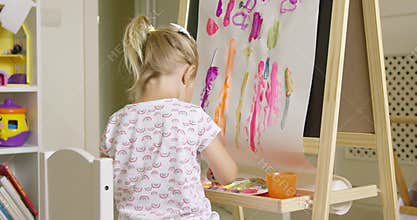 Cute creative little girl artist painting