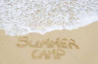 Sign Summer Camp on the sandy beach