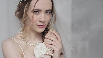 Closeup brunette bride with fashion wedding hairstyle and makeup