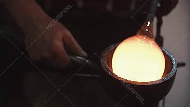 Glass workshop. Blowing glass products, the process of manufacturing the product, close up