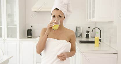 Girl after shower with glass of juice