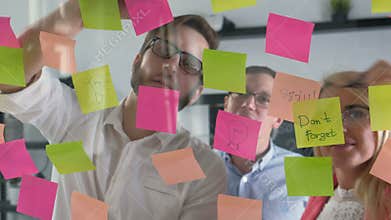 Creative business team brainstorming ideas working together sharing data late at night after hours in modern glass